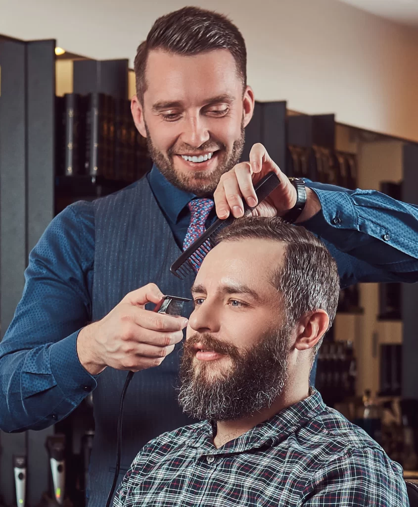 Barber cutting hair with machine